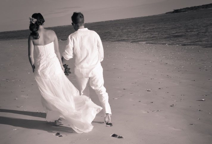 Couple after wedding walking on beach