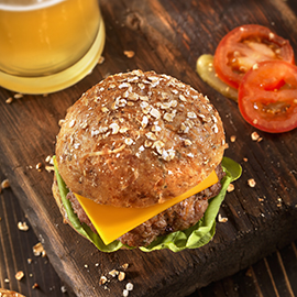 Cheeseburger and a Beer on a Rustic Wood Cutting Board